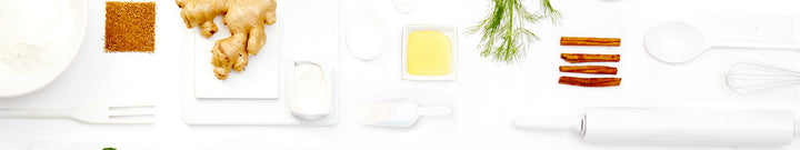 a simple tabletop background featuring white kitchen tools and various ingredients in simply products