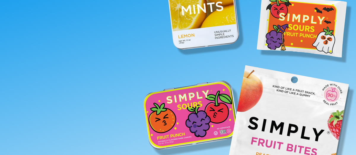 Four Simply branded fruit snack products arranged on a bright blue gradient background: lemon mints, sour fruit punch, grapefruit punch, and peach & raspberry fruit bites. The products include both tins and a bag, with colorful fruit illustrations and readable packaging text.