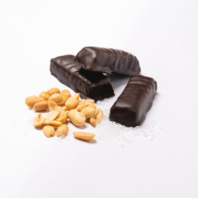 3 Simply Candy Bars in a pile with peanuts