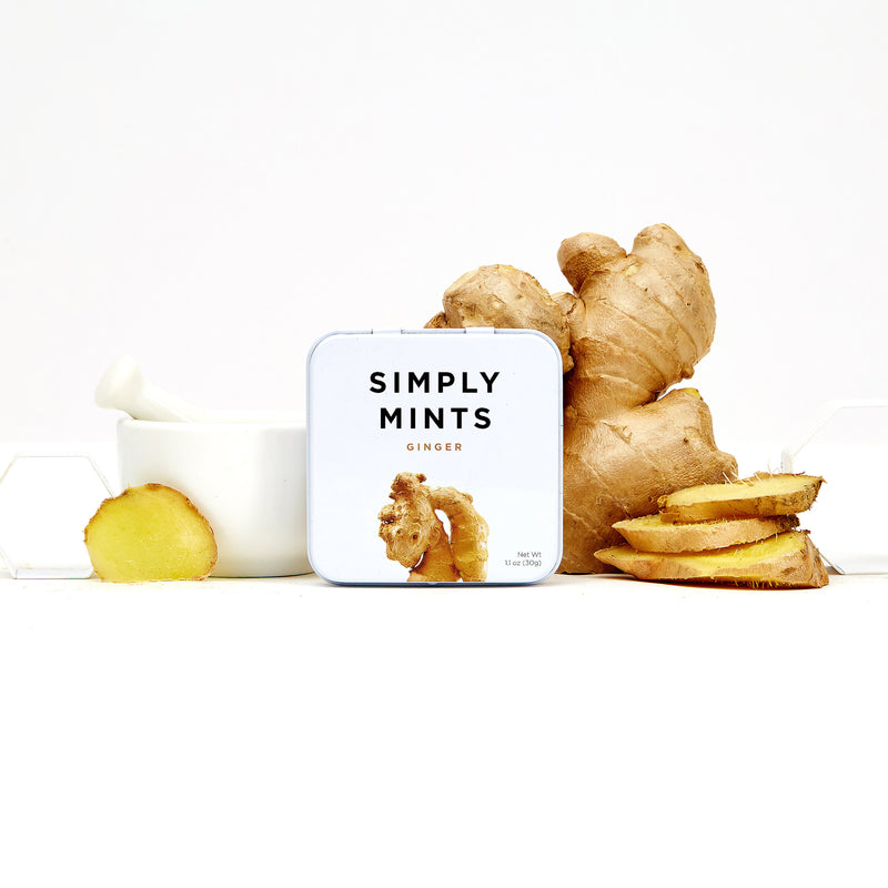 Tin of Simply Mints on table with fresh ginger