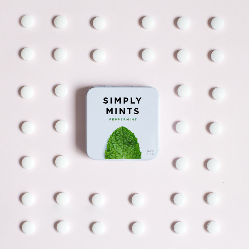 Tin of Peppermint Mints on table with loose mints