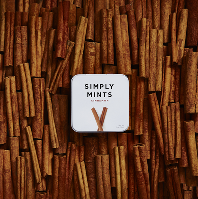 Tin of Cinnamon Mints on top of Cinnamon sticks