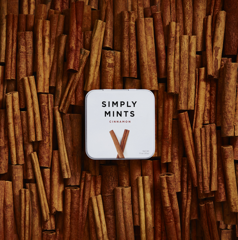 Tin of Cinnamon Mints on top of Cinnamon sticks